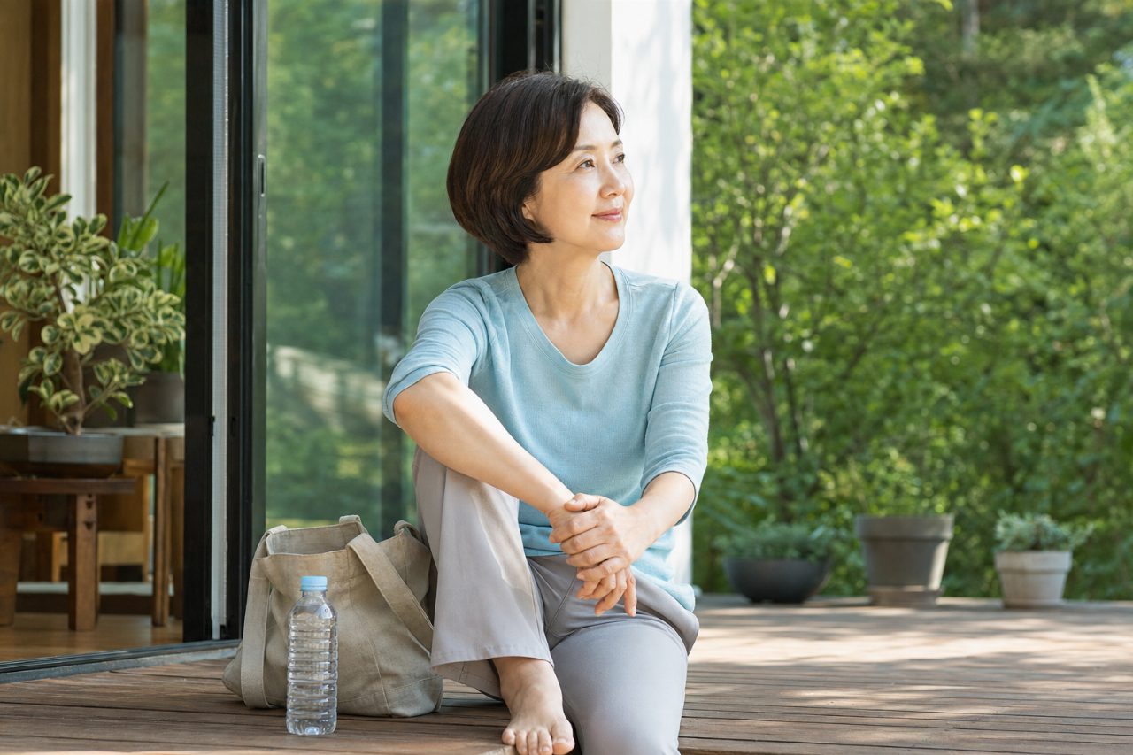 잔잔한 자연광 아래 작은 물병이 휴대용 가방 옆에 놓여 있다.
